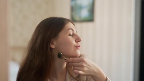 Woman Uses Jade Roller for Facial Massage