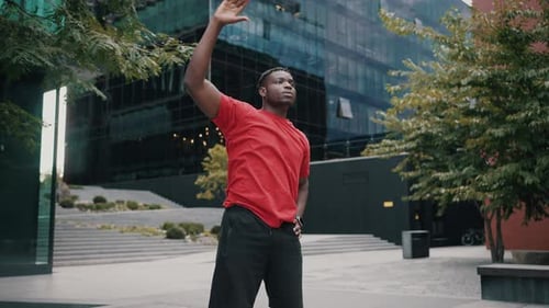 Man Stretching Torso and Arms in Urban Setting
