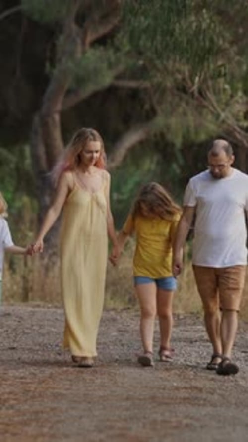 Family Enjoying a Leisurely Walk Along a Tranquil Dirt Road
