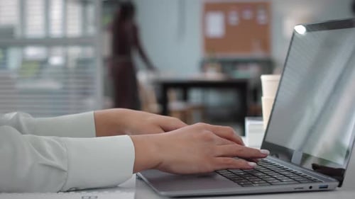 Hands of Businesswoman Typing on Laptop in Office