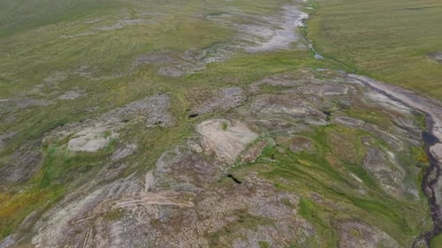 Aerial View of Rocky Tundra Plateau with Pond and Green Vein Near Lavrentiya