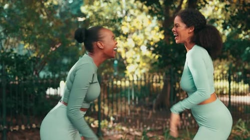 Happy Women High-Fiving After Exercising Outdoors