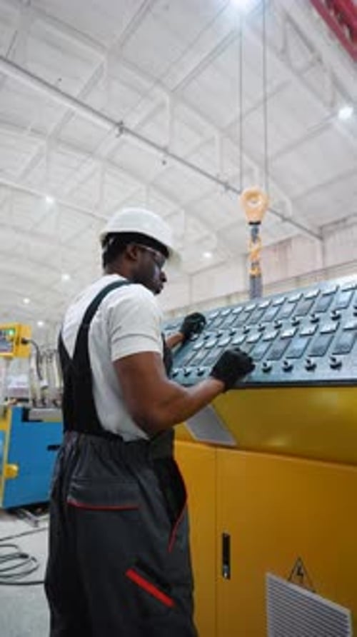 Worker On Factory Analyzes The Production Process And Programming Industrial CNC Machine Tool