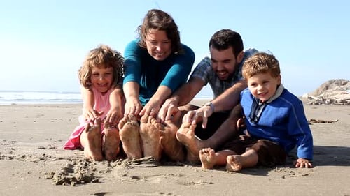 Family Sitting in Sand at Beach 30-35
