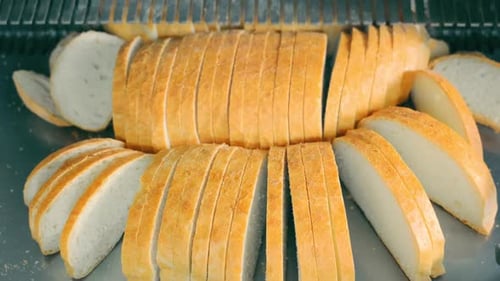 Slicing Bread in the Bakery Automatic Line for Cutting Pieces of Bread Sliced Bread