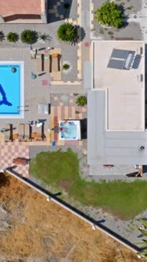 Bird's Eye Perspective of a Sparkling Jacuzzi Next to a Turquoise Resort Pool, Mediterranean Villa