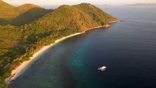 4K drone video flying backwards to reveal more of a beautiful tropical island paradise in Palawan, P