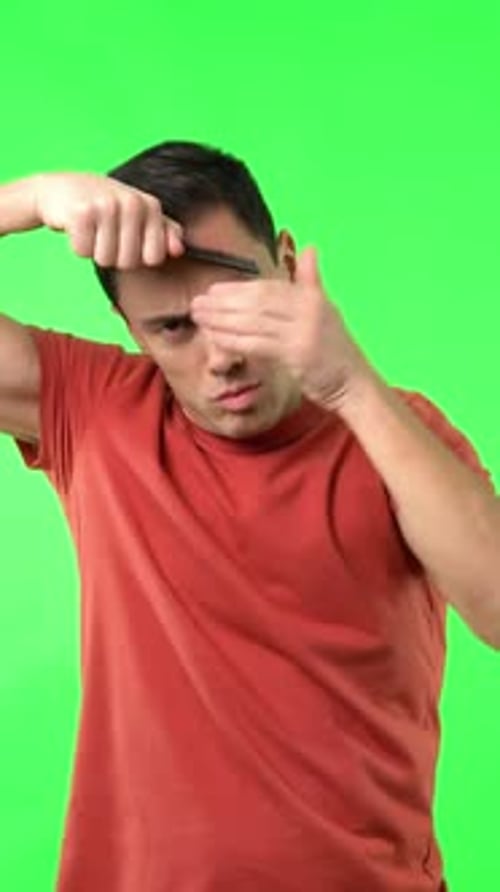 Man Styling and Tousling Hair on Green Screen