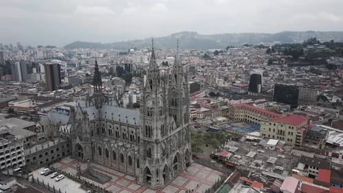 Aerial view of cityscape in Quito and Basilica in foreground during daylight