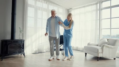 Nurse Helps Old Wheelchair Man to Walk Physical Therapist Woman Provides Medical Help Support to