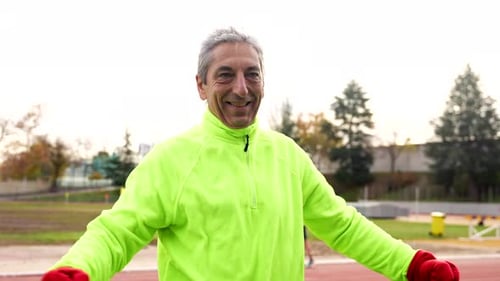 Mature Man Stretching Before Exercising Outside