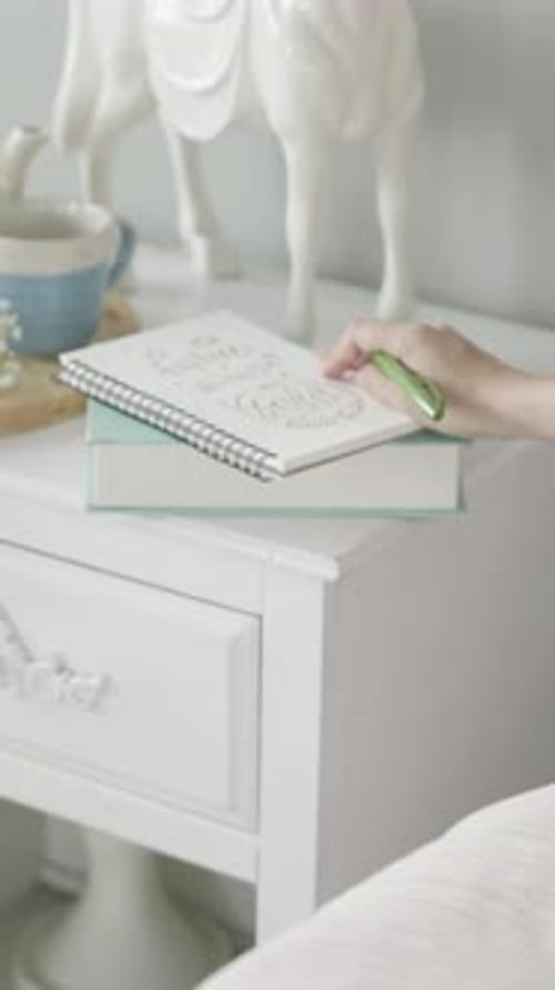 Person Drawing in a Sketchbook at Home