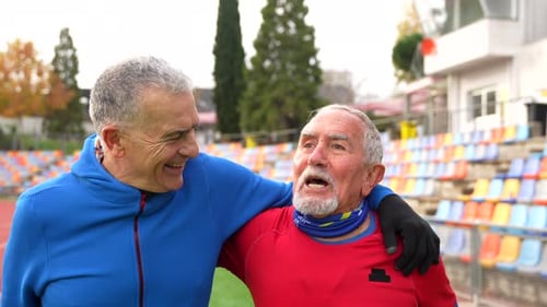 Elder Men Warming Up in an Athletics Field Together