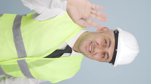 Vertical video of Engineer waving at camera.