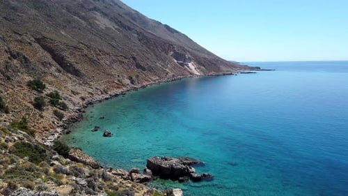 Panoramic view of the meeting between the arid Cretan mountains and the turquoise waters of the Liby