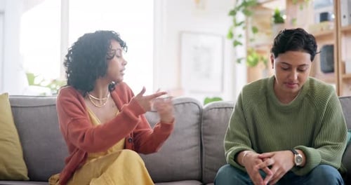 Adults Talking and Gesturing on Couch