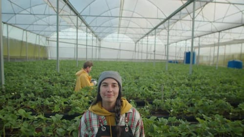 Portrait of Young Female Farm Worker in Greenhouse