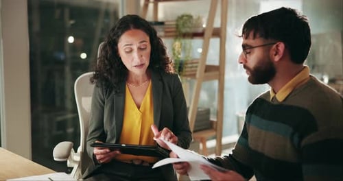 Business Meeting with Tablet Discussion at Office Desk