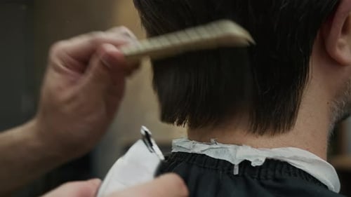 Man Getting Haircut in Barbershop Close Up