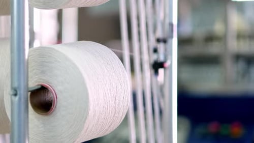 Yarn Spools Unwinding in Textile Factory