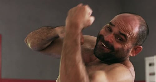 4k video footage of a muscular male boxer practicing in the gym