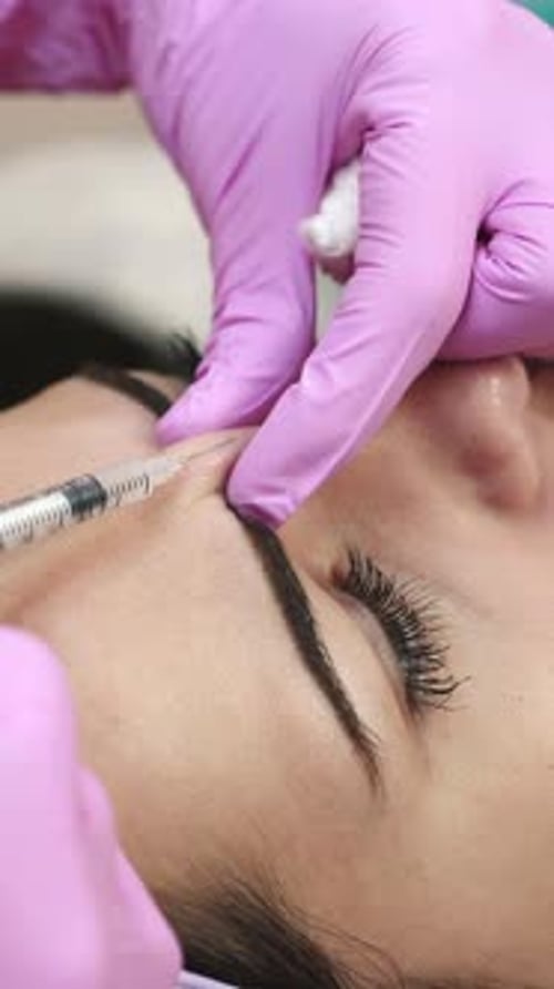 Woman Receives Forehead Injection for Cosmetic Enhancement