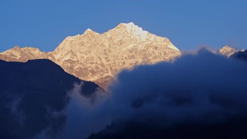 Aerial View of Misty Clouds Parting to Reveal Snow Covered Mount Everest Rising Above Himalayan