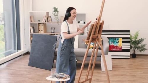 Lady in Headphones Getting Inspired By Music in Art Space