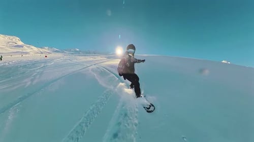 Snowboard powder snow freeride. Professional snowboarder ride down the mountain slope at sunny winte