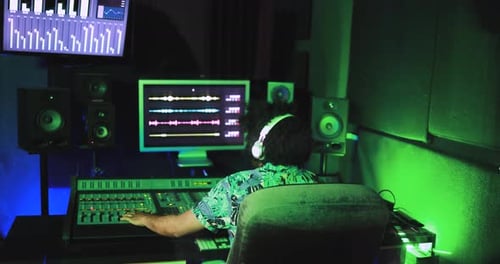 South african sound engineer mixing tracks inside boutique recording studio