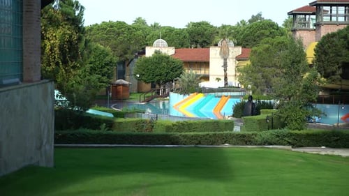 empty pool with colorful slides in the forest 4K