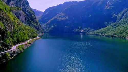 Sunlight reflected in the bright aurlandsfjord in Norway. Drone dolley shot