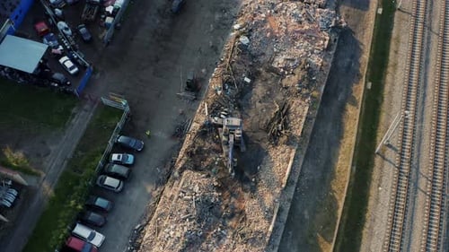 Drone Shot Top View an Excavator at a Construction Site Demolishing a House