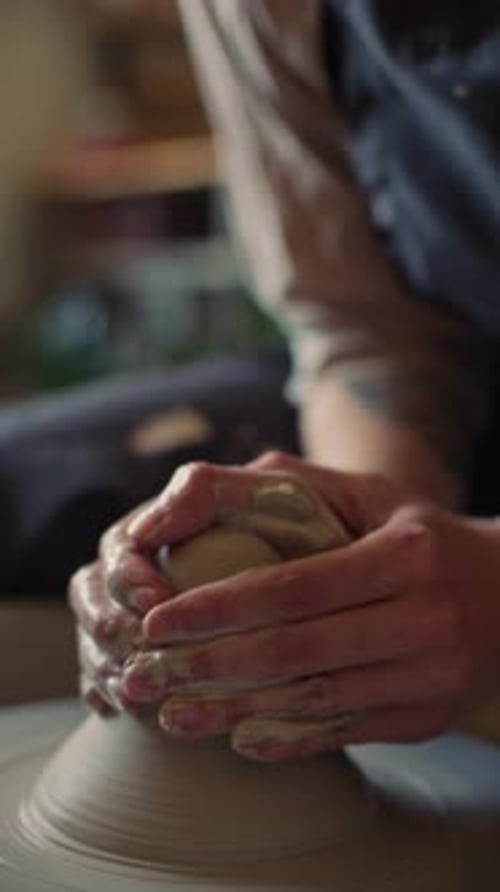 Close-Up of Ceramic Artist Shaping Moistened Clay on Spinning Pottery Wheel
