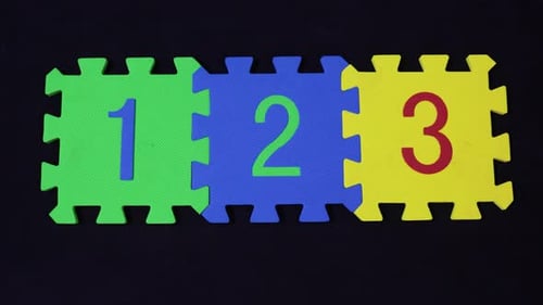Colorful Number Puzzle Pieces on Black Background Zoom