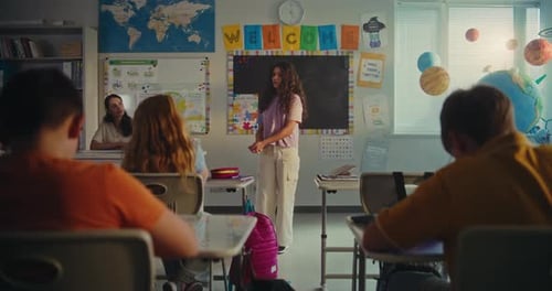 Primary School Girl Showcasing Knowledge of Ecology in Front of Class and Female Teacher
