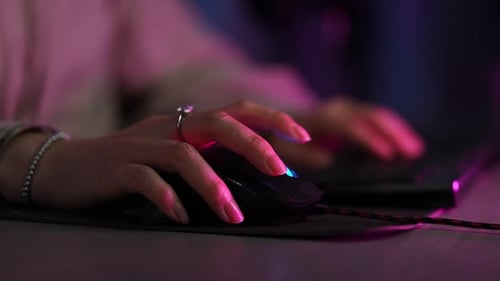 Woman Using RGB Computer Mouse and Keyboard