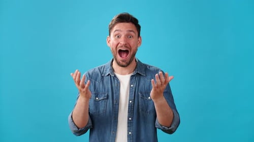 Happy Young Adult Expressing Positive Emotions on Blue