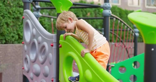 Child Playing on Colorful Playground Equipment