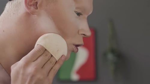 Queer Man Doing Face Contouring while Applying Makeup