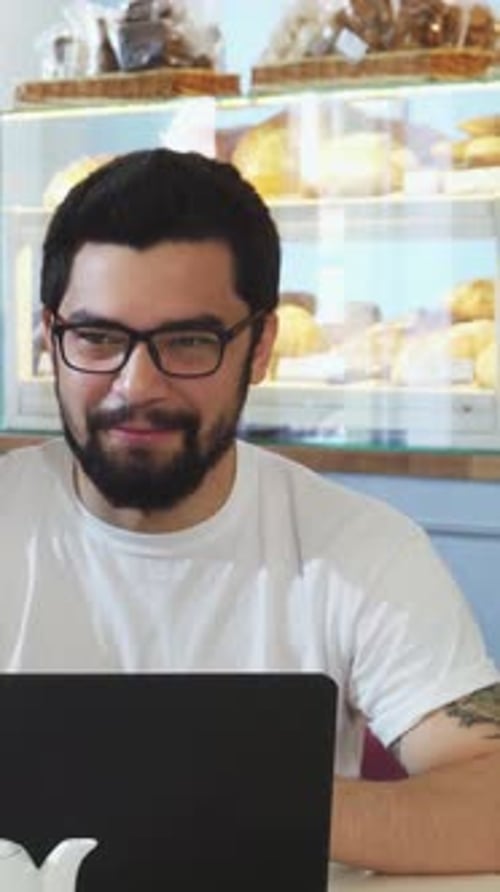 Friends Sharing Laughter and Delicious Breakfast at a Cozy Coffee Shop