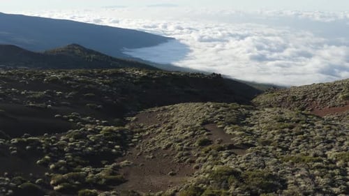 Exhilarating aerial view over national park and cloud bank in Tenerife, drone slow panning left and