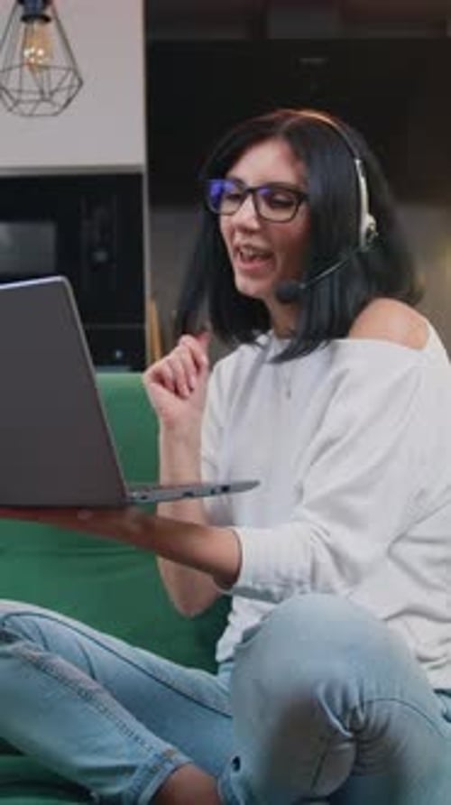 Smiling Woman Video Calling on Laptop in Living Room
