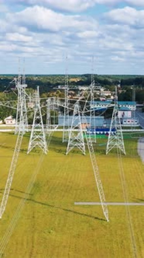 High voltage tower electricity station. Aerial view of electrical voltage wires. Vertical video