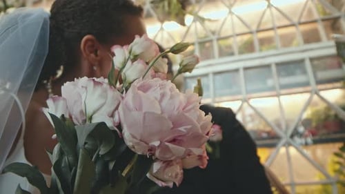 Beautiful Bride Holding Flowers on Wedding Day