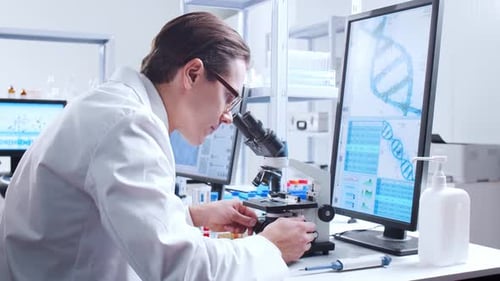 Scientist Uses Microscope in Bright Laboratory