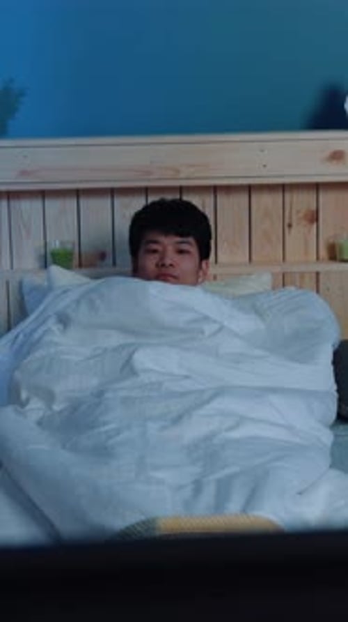 Cozy Morning Vibes A Relaxed Young Man Nestled Comfortably Under Warm Soft Blankets