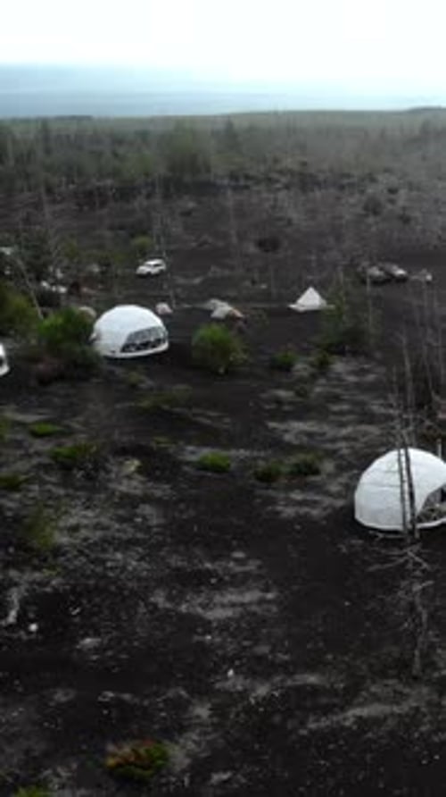 Geodesic Dome Tents in Volcanic Landscape Aerial View Media