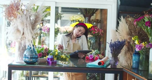 Charming Asian Florist Wearing Apron Working in Flower Store Attractive Female Seller Calling