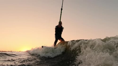 Dynamic Sunset Wakeboarding Thrilling Moments of Adventure on Water As the Sun Sets Spectacularly on